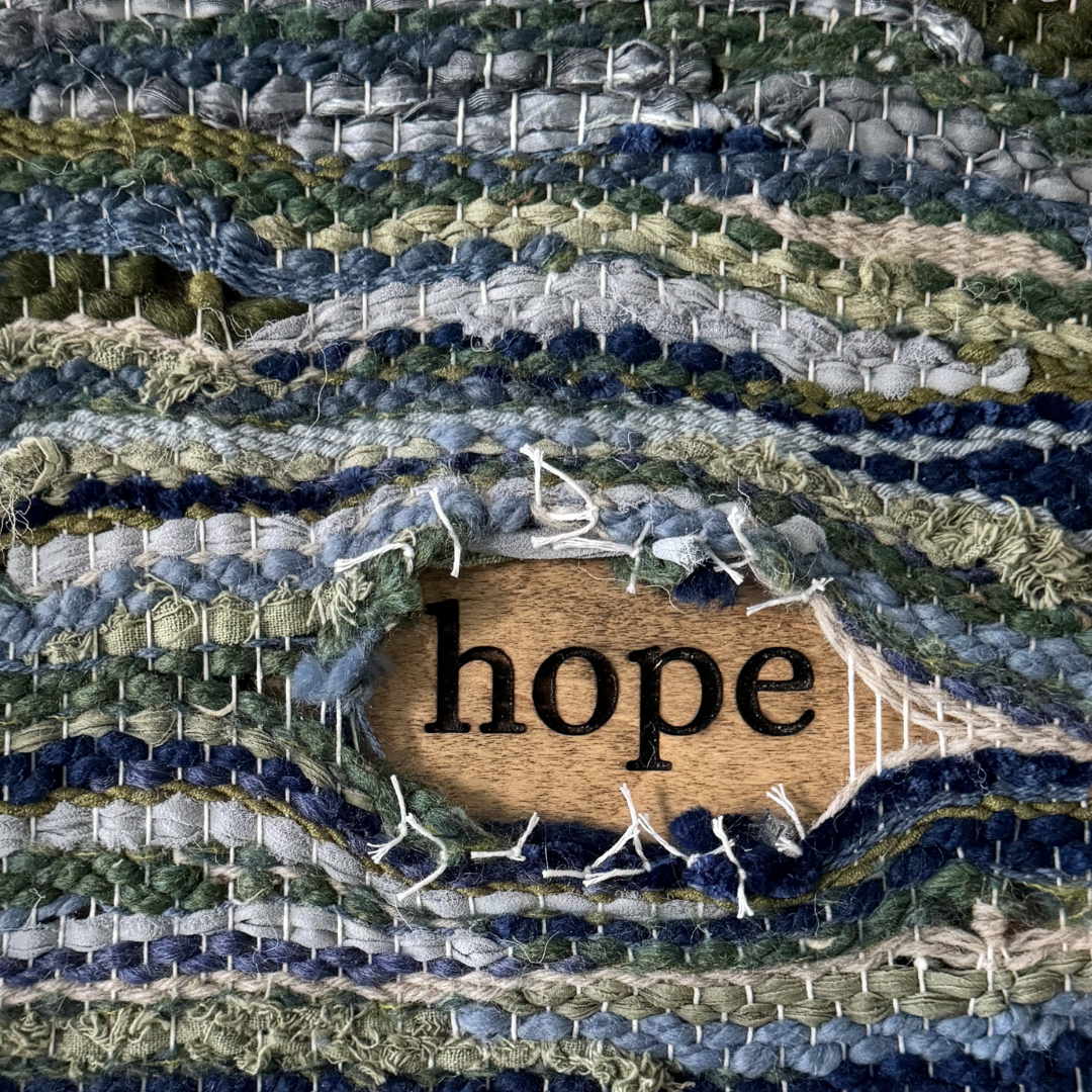 Woven fabric reveals word "hope