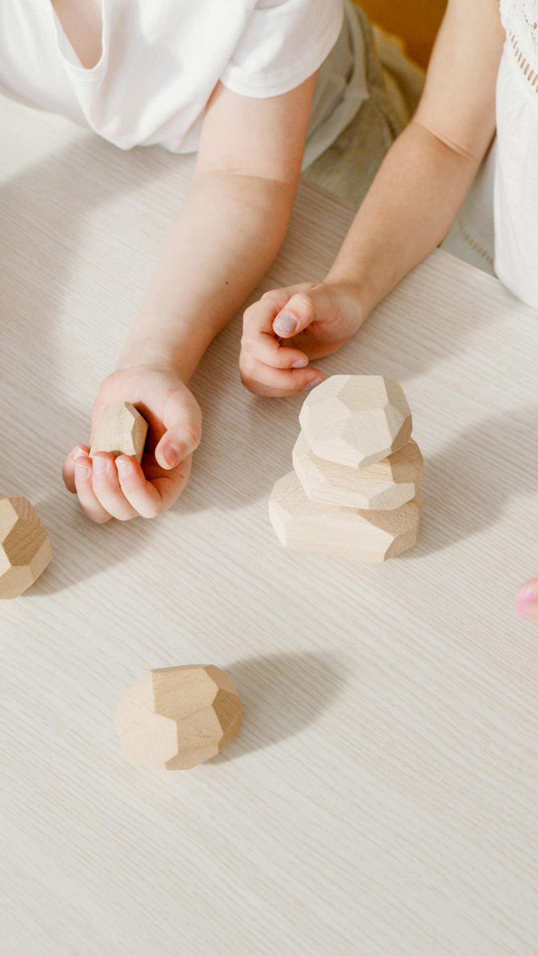 Children playing with wooden geometric blocks
