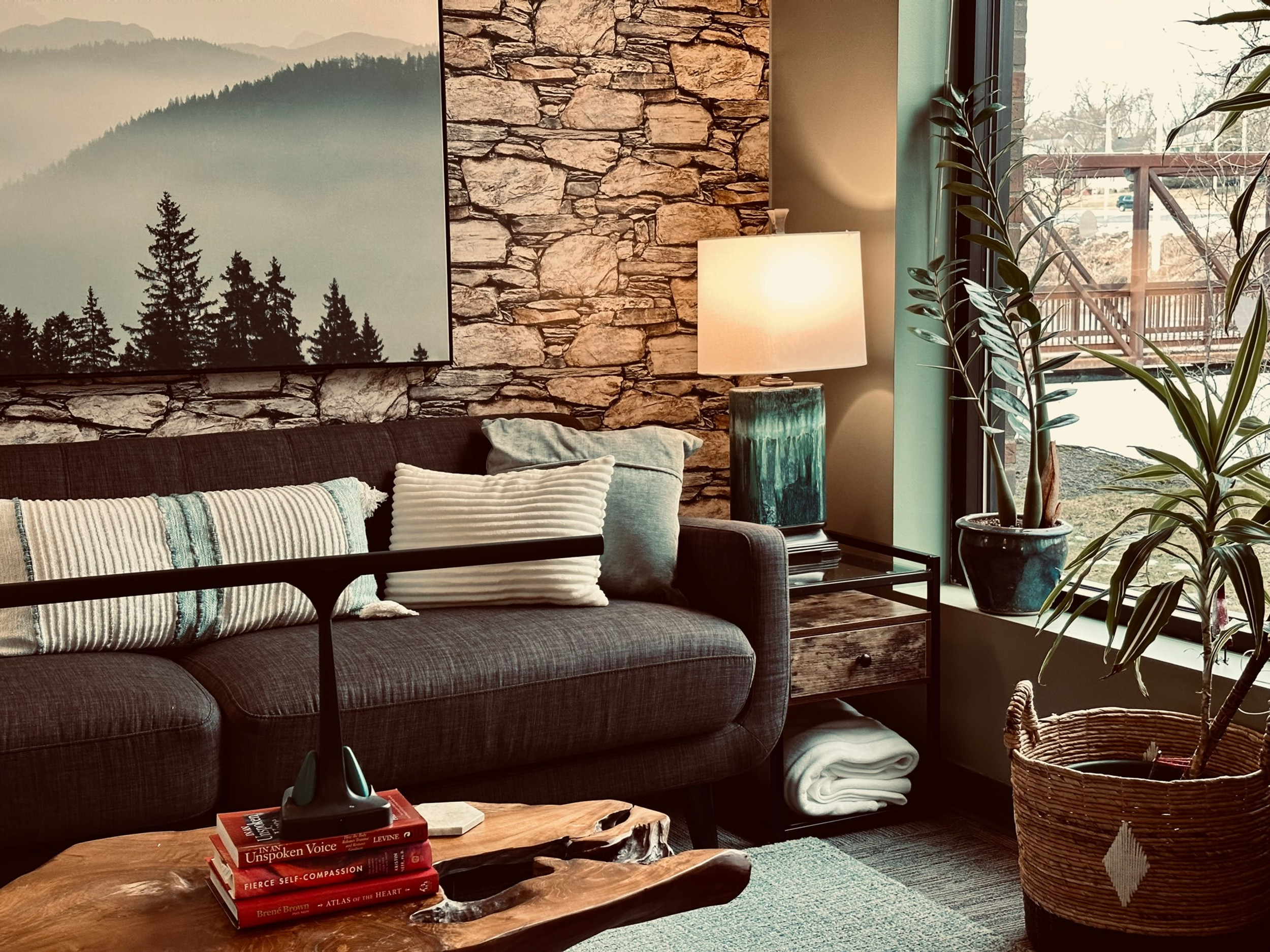 Cozy living room with plants and mountain art